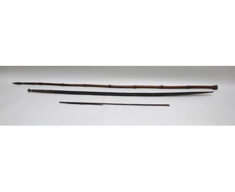 A LATE 19TH CENTURY LONGBOW, possibly South Seas, with woven tip, bow 185cm long, together with TWO ARROWS and a possibly AFR