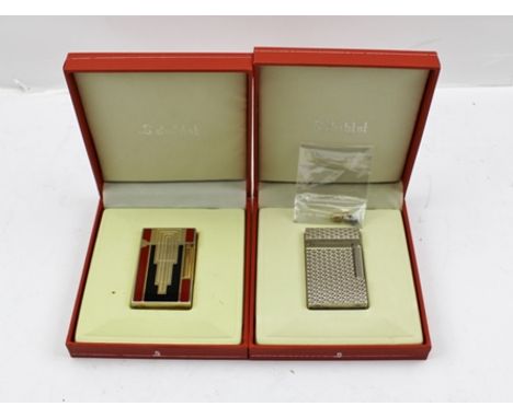 TWO "DUBTNT" OF PARIS CIGARETTE LIGHTERS, in original boxes, one is of Art Deco design with red and black enamel decoration 
