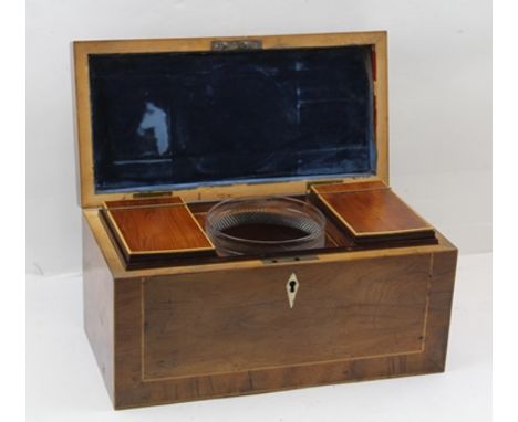 A 19TH CENTURY YEW WOOD TEA CADDY, the lid crossbanded and string inlaid, opens to reveal a pair of inner lidded caddies eith