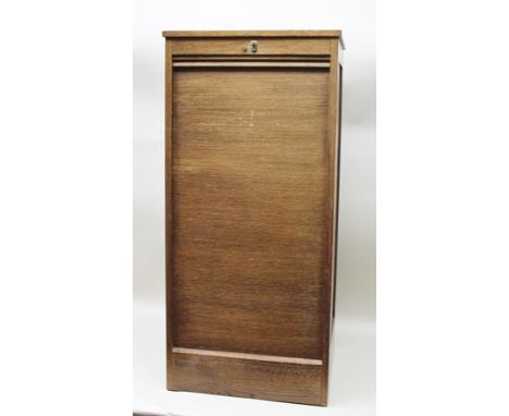 AN "ASTROLA" EDWARDIAN OAK TAMBOUR DOOR CABINET, with press button releasing door to reveal slides within, 52cm wide x 111cm 