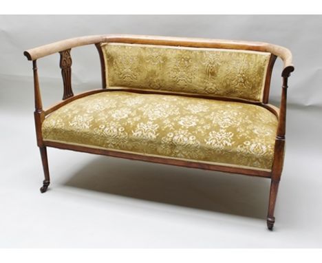 AN EDWARDIAN BEECH FRAMED TWO SEATER SALON SOFA having carved and pierced arm support splats, on turned supports, cut gold fa