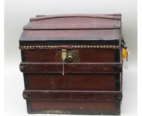 A VICTORIAN DOME TOP TRAVEL TRUNK of banded stained pine construction with metal reinforced edges and brass studded detail to
