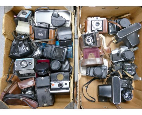 A collection of camera equipment to include Polaroid SX-70 Land camera, Agifold bellows camera, Video Camera Lens, Praktica M