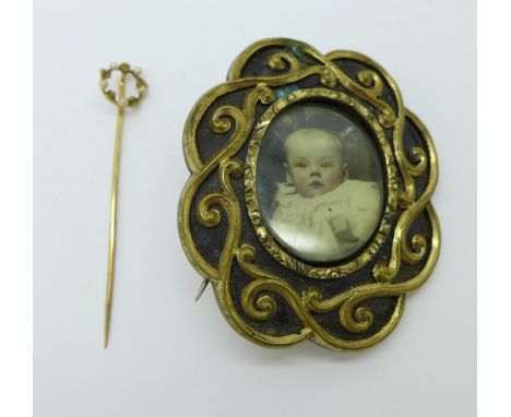 A yellow metal and seed pearl stick pin and a memorial brooch