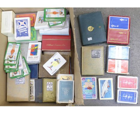 A collection of playing cards and playing card boxes including Bakelite