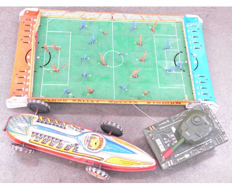 A Chad Valley Soccer Stadium, a tin plate tank and a tin plate racing car, made in Great Britain, all a/f