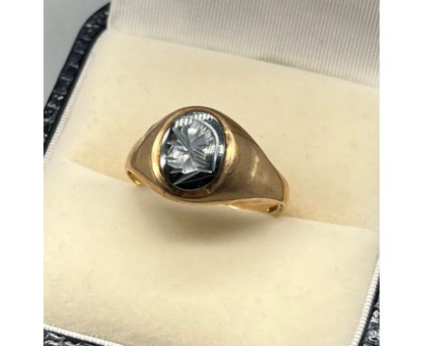 9ct yellow gold and onyx signet ring. Engraved centurion head to onyx panel. [2.48grams] [Ring size Q] 
