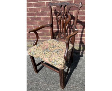 Antique Chippendale style arm chair. Designed with a floral material seat. [95cm high] 