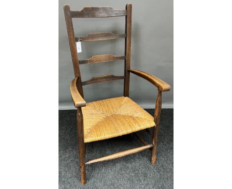 A 19th century ladder back arm chair. [106cm high] 