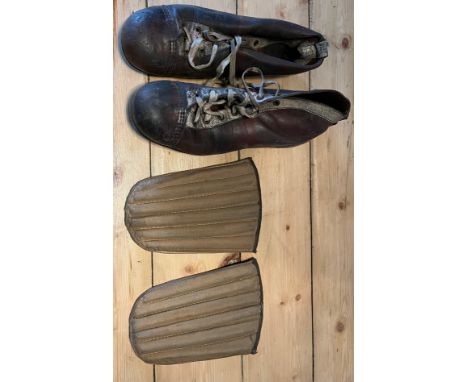 A Pair of antique/ vintage leather JEN Football boots and shin pads. 