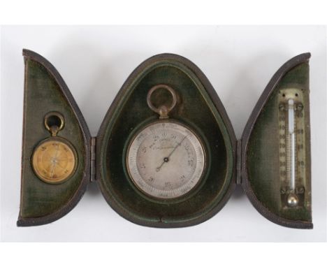 A POCKET BAROMETER with a circular silvered dial and a gilt metal body, in a triptych style leather travel case with a miniat