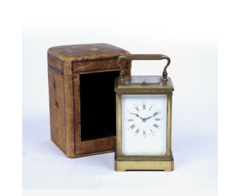 A 19th century brass carriage clock, with white enamel dial, the movement with push repeat, striking on a gong, in gorge case