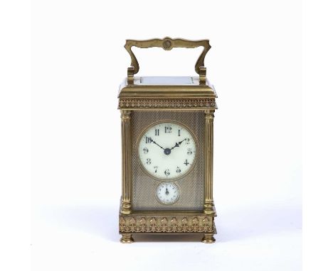 A late 19th century French brass carriage clock, with circular enamel dial above a subsidiary alarm dial, the movement with b