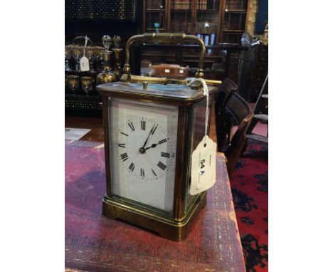 A French brass repeater carriage clock with white enamel dial, 14cm high