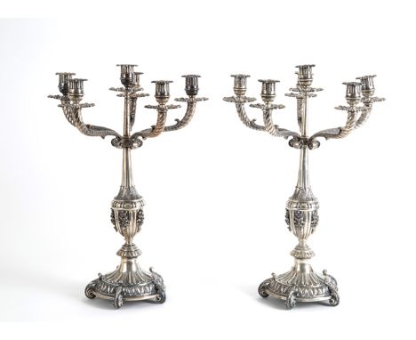 Pair of six-flame candelabra in finely chiselled silver, approx. 4600 gr. Early 19th century. 50x35 cm approx. Coppia di cand