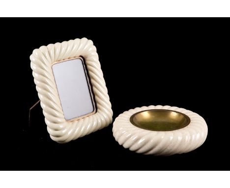 TOMMASO BARBI (Firenze 1944-2015). Cream colored ceramic ashtray and frame. The first with brand on the bottom and the second