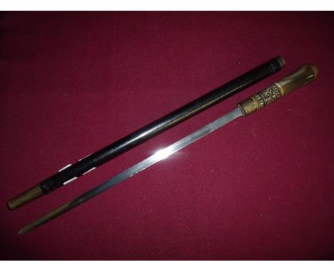 Early 20th C Indian sword stick with 14 inch blade, with carved horn grip, lion head pommel and ebonised stick sheath 