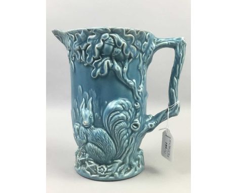 WADE PITCHER,decorated with animals amongst foliage in relief on blue ground, 21cm high, along with other ceramics including 