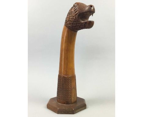 CARVED WOOD MYTHICAL CREATURE,formed as a Celtic type snake, on an octagonal base, 39cm high, along with other treen items in