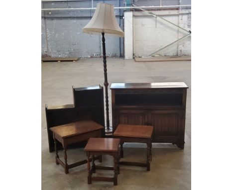 Furniture - a nest of three oak occasional tables; an elm standard lamp; a linen-fold hall cupboard and small bookcase 