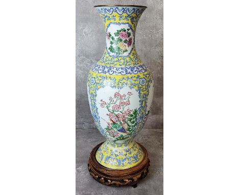 A Chinese hand painted enamel baluster shaped vase the body birds and flowering prunus set against a yellow ground with lotus