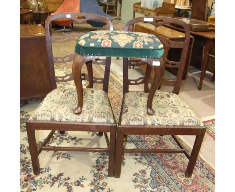 Two George III mahogany ladder-back dining chairs, on square chamfered front legs and a Georgian upholstered stool on carved 