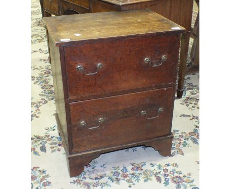 An oak chest of two drawers, on bracket feet, 60cm wide, 74cm high, (converted commode).