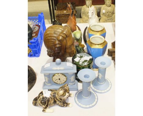 A small ceramic Winstanley cat, 10cm high, 18cm long, a modern Wedgwood jasperware clock and a pair of candlesticks, a Mary-G
