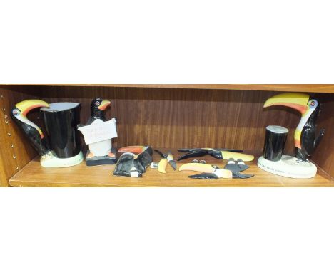 A collection of modern Carltonware Guinness advertising items, including a Toucan lamp base, Toucan water jug, three flying T
