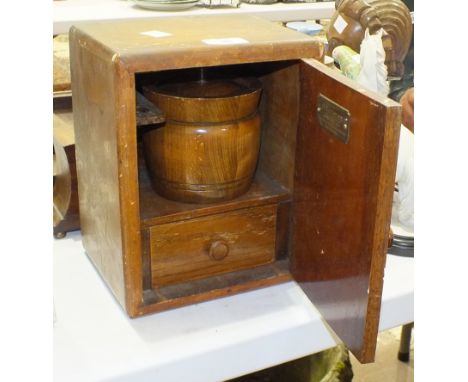 A walnut smoker's cabinet with oak tobacco jar, a small inlaid wood mantel clock and an oak hall mirror and brush set, (3).