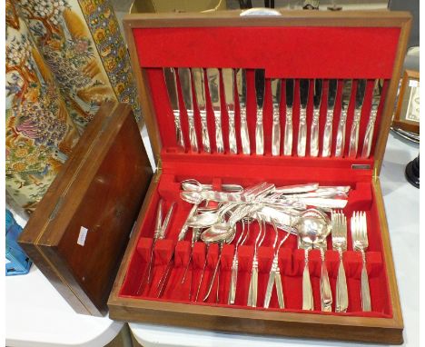 A Flexfit canteen of plated cutlery cased together with six mother-of-pearl-handled forks and five knives, in mahogany fitted