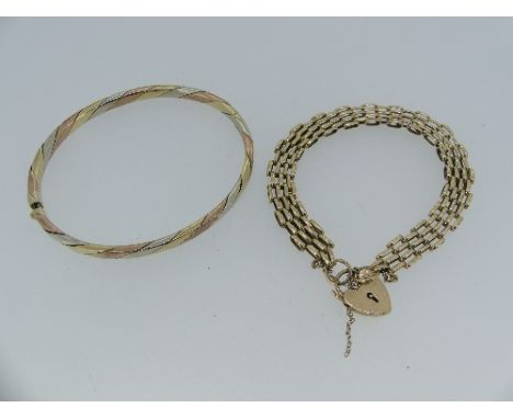 A 9ct tri-colour gold Hinged Bangle, formed of twisted white, yellow and rose bands, marked on the integral snap 9k, together