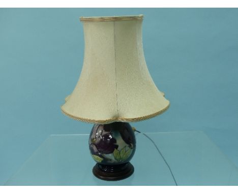 A Moorcroft pottery Anemone pattern Table Lamp, of baluster form, with wood base and shade, overall 16½in (42cm) high.