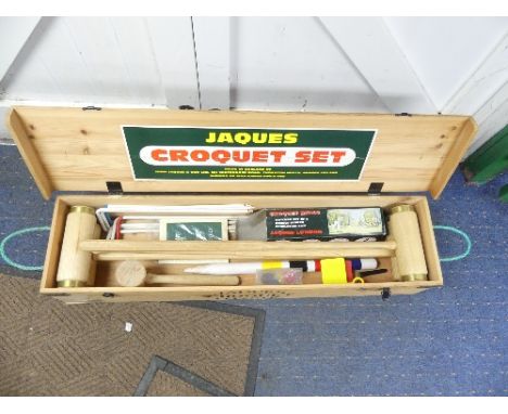 A modern Jaques Croquet Set, complete with brass bound colour coded mallets and set of four balls, unused, plastic flags and 