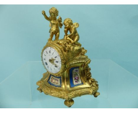 A 19th century French ormolu figural cased Mantel Clock, the case decorated with two seated cherubs and Sevres style porcelai