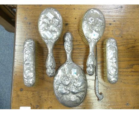 A near matched Edwardian silver backed five piece Dressing Table Set, hallmarked London and Birmingham, 1902, with Cherub dec