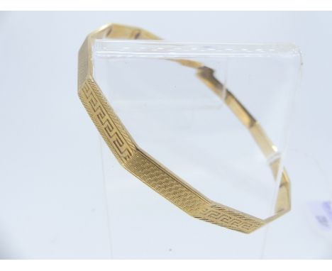 A 9ct gold Salve Bangle, with alternate sections of engine turned decoration and Greek Key design, 3in (7.5cm) diameter, appr