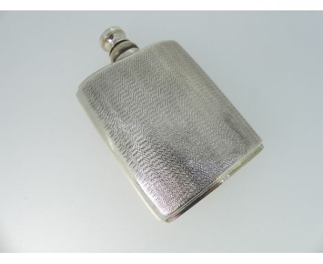 A George V silver Scent Bottle, hallmarked Birmingham, 1928, of shaped rectangular form with engine turned decoration,the spr