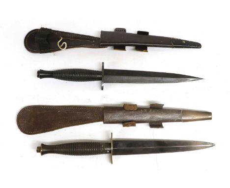 Two British Third Pattern Commando Knives, each with machine forged steel blade, ribbed alloy grip and leather scabbard with 