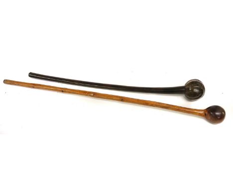A 19th Century Zulu Knobkerrie, of rich dark brown patinated hard wood, with facetted globular head and slightly curved cylin