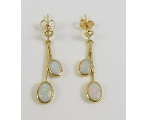 A pair of 18ct gold white opal drop earrings, the two oval cabochon cut stones in rub over settings, 3.2cm long, 2.8g gross