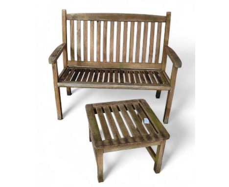 A wooden garden bench, of slat formation, together with a similar table, the bench 111cm wide