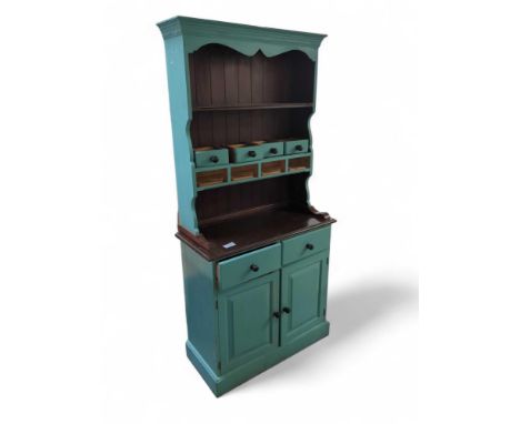 A painted pine kitchen dresser the shelved top fitted with four spice drawers, the base with two short drawers over cupboard 