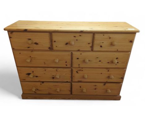 A modern pine chest of three short drawers over three pairs of short drawers on plinth base 95cms high 137cms wide 45cms deep