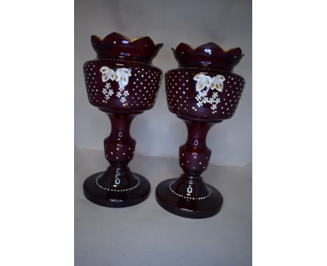 A pair of Victorian ruby glass lustre frames having enamel detailing, missing drops.
