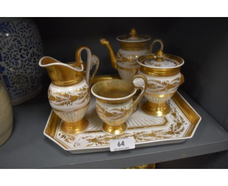 A 19th century hard paste bachelor set having tray,cups,jug,pot and sugar basin with lid,having richly gilded decoration on w