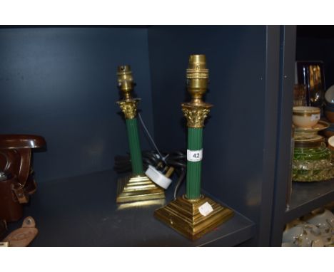 A pair of vintage brass columned table lamps having painted green stems.