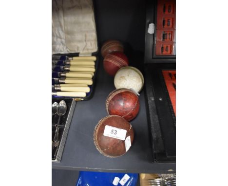 Five vintage leather cricket balls.