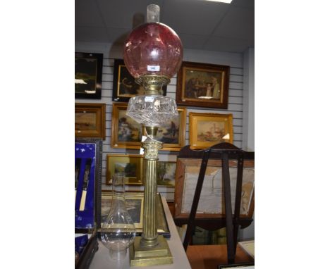 An impressive Victorian oil lamp having cranberry glass shade,clear reservoir and ornate brass corinthian column.
Shade and b