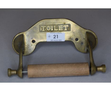 A Vintage brass and wood toilet roll holder.